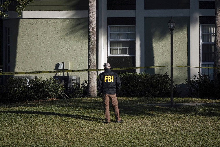 Law enforcement personnel continue to work at an apartment complex on Feb. 3, 2021, the day after a deadly shooting that killed several FBI agents.