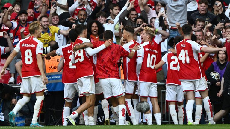 Arsenal players celebrate with their fans after beating Manchester City on penalties to win the Community Shield