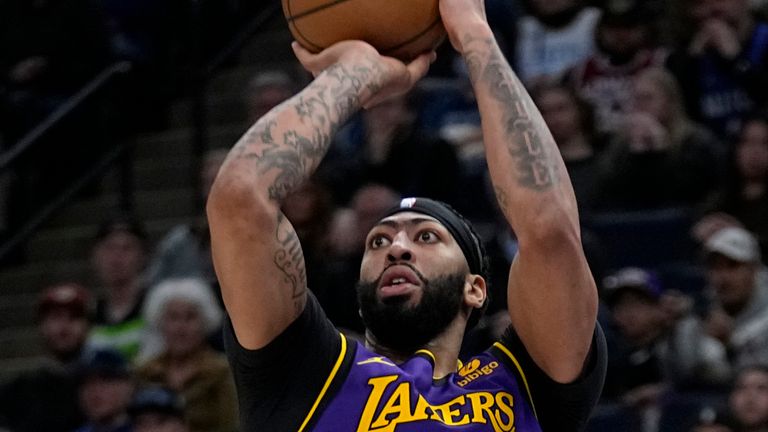 Los Angeles Lakers forward Anthony Davis shoots against the Minnesota Timberwolves during the second half of an NBA basketball game Friday, March 31, 2023, in Minneapolis. (AP Photo/Abbie Parr) 