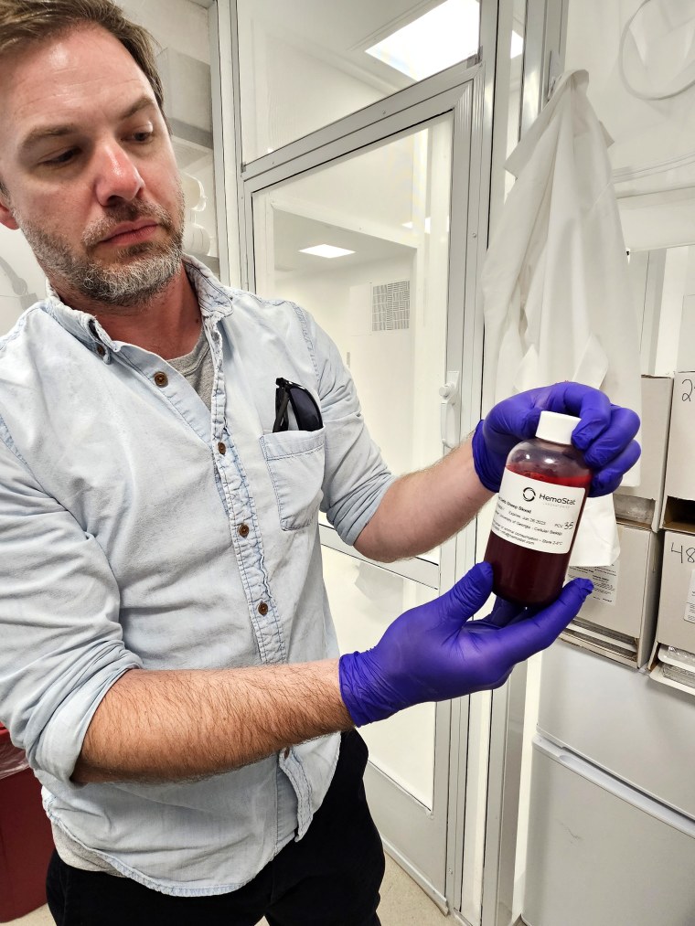 Ronald Drew Etheridge, an assistant professor at the University of Georgia, studies the molecular tools used by the Trypanosoma cruzi parasite to make itself at home in various target environments. He is holding the kissing bug’s favorite food: blood.