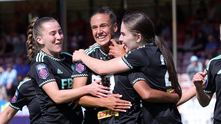 Ava Baker is mobbed by her team-mates after scoring for Leicester at Brighton