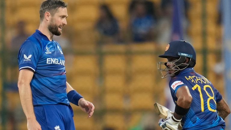 England's Chris Woakes reacts after Sri Lanka's Pathum Nissanka hits a four on his delivery during the ICC Men's Cricket World Cup match between England and Sri Lanka in Bengaluru, India, Thursday, Oct. 26, 2023. (AP Photo/Aijaz Rahi)