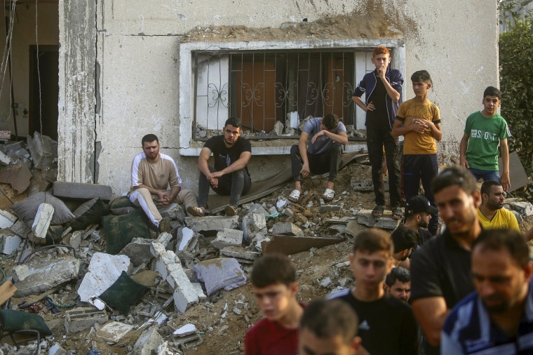 People inspect the damage of a destroyed house in Khan Younis, Gaza.