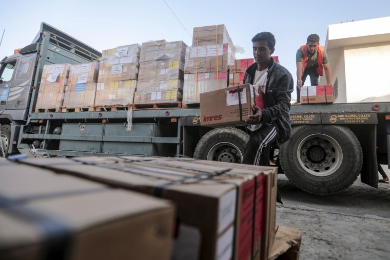 People unload boxes of medicine at Nasser Medical Complex in Khan Younis, Gaza.