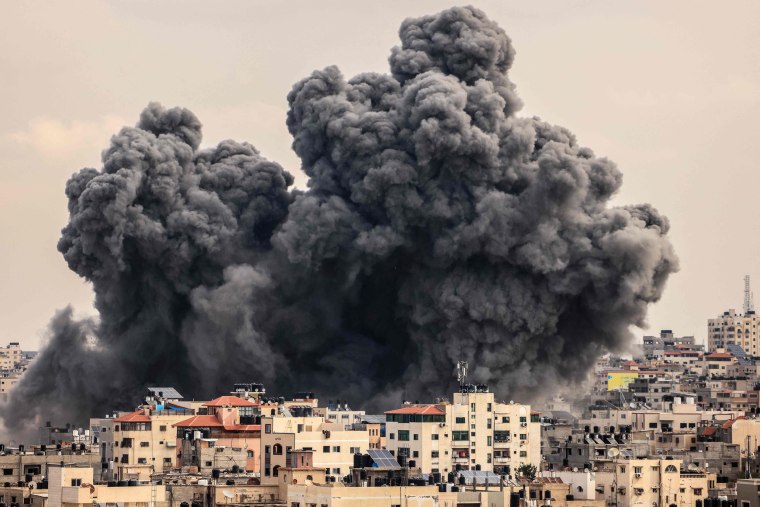 A plume of smoke rises in the sky of Gaza City