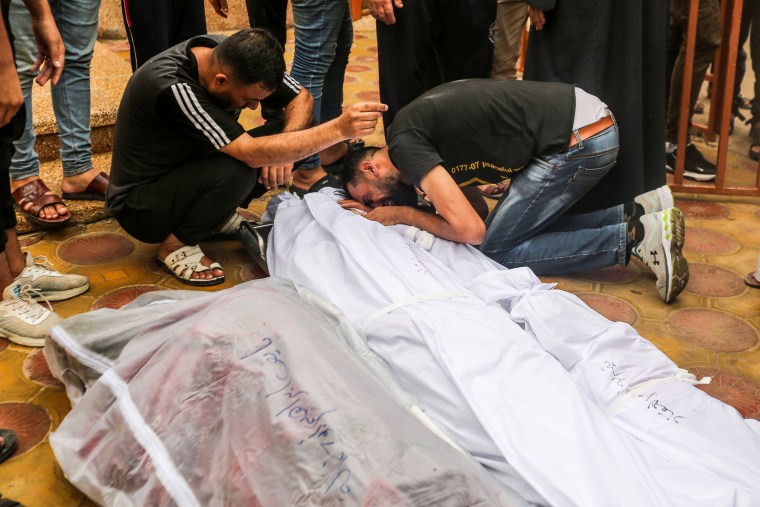 People mourn as they collect the bodies of people killed in Khan Younis, Gaza.