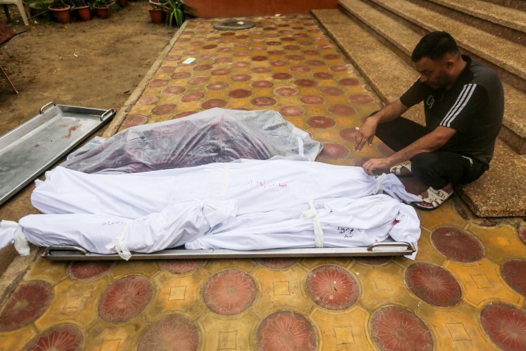 People mourn as they collect the bodies those killed in Khan Younis, Gaza.