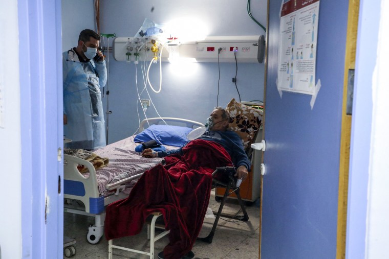 A nurse checks on a Covid-19 patient in the ICU at al-Ahli hospital on March 19, 2021.