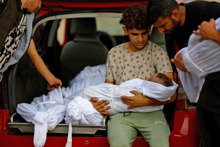 Members of the al-Zanati family killed in airstrikes are transported to a cemetery for burial in Khan Younis in the southern Gaza Strip on Oct. 23, 2023. 