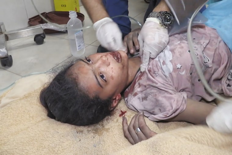 A girl is treated on a hospital floor after she was pulled from the rubble in Gaza.