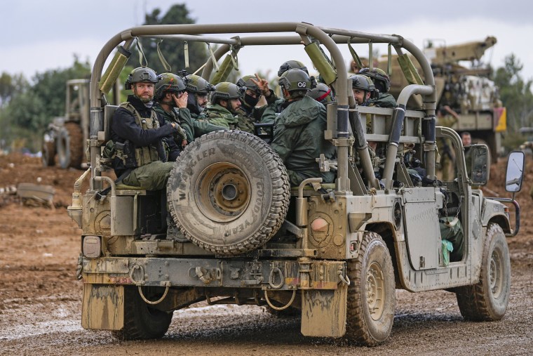 Israeli soldiers move near the border with the Gaza Strip on Nov. 27, 2023. 