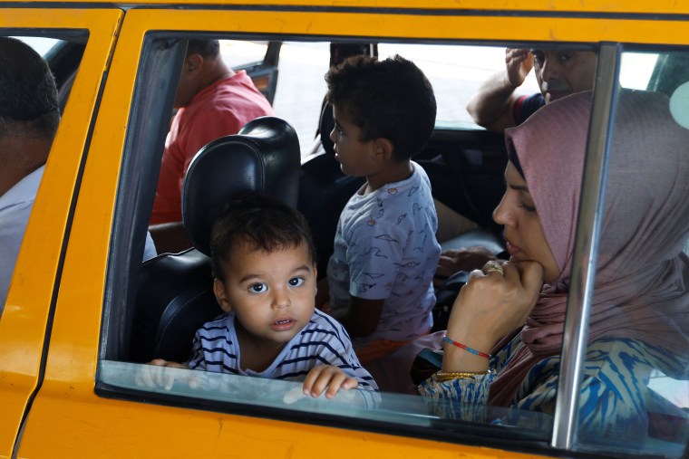 Palestinians, including foreign passport holders, wait at Rafah border crossing, in Rafah