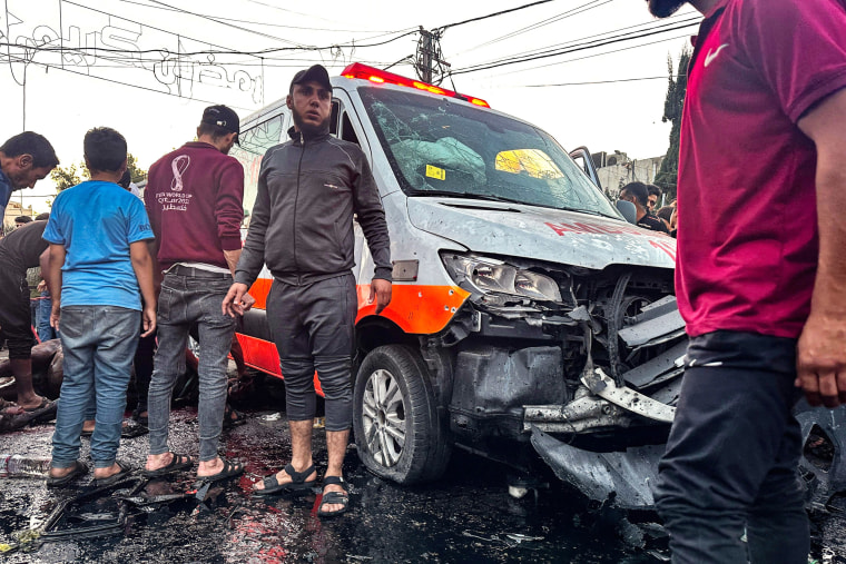 People gather around an ambulance damaged in a reported Israeli strike in Gaza