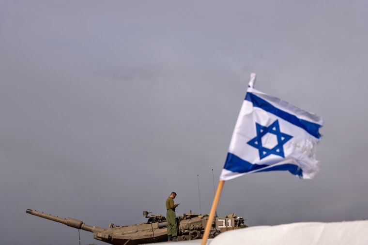 Members of the Israeli Defense Forces work at a staging area near the border of Gaza on Nov. 27, 2023. 