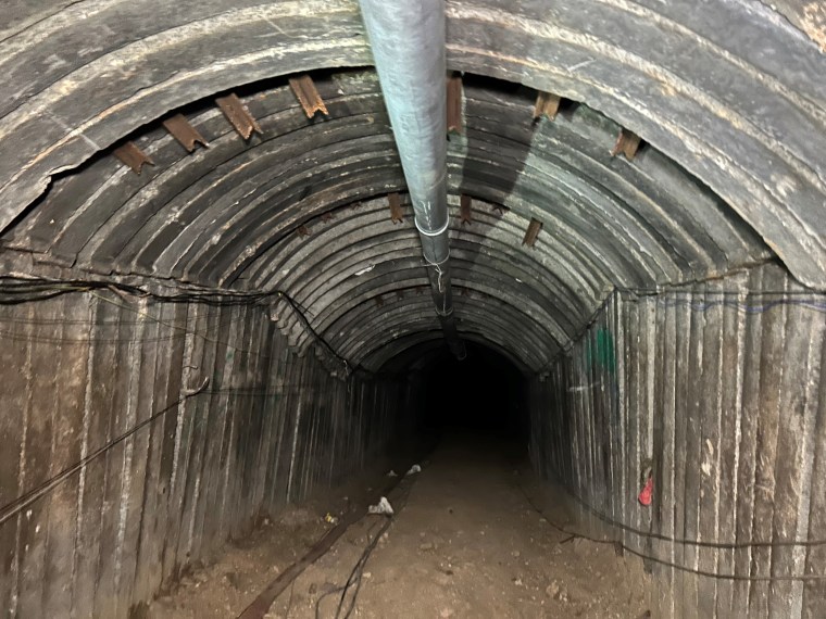 Although Israel’s military believes it has cleared any Hamas presence from the tunnel, troops with weapons drawn stand guard part way inside. 