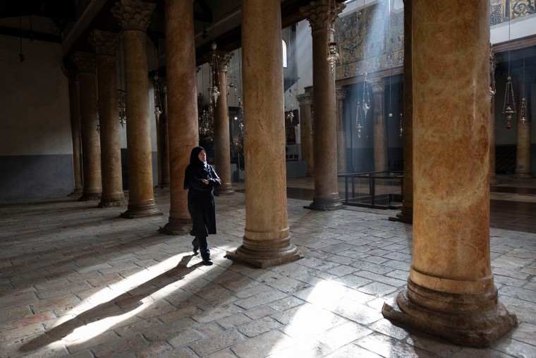 A worshiper walks in empty Church of Nativity on Dec. 25, 2023 in Bethlehem, West Bank.