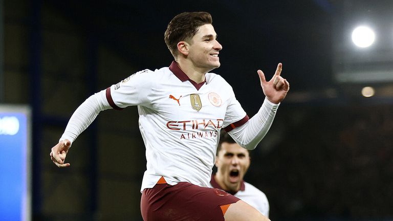 Julian Alvarez leaps in celebration after converting a penalty to give Man City a 2-1 lead at Everton