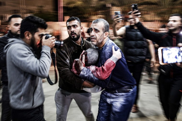 Gazans arrive at hospital after bombing in Khan Younis. 