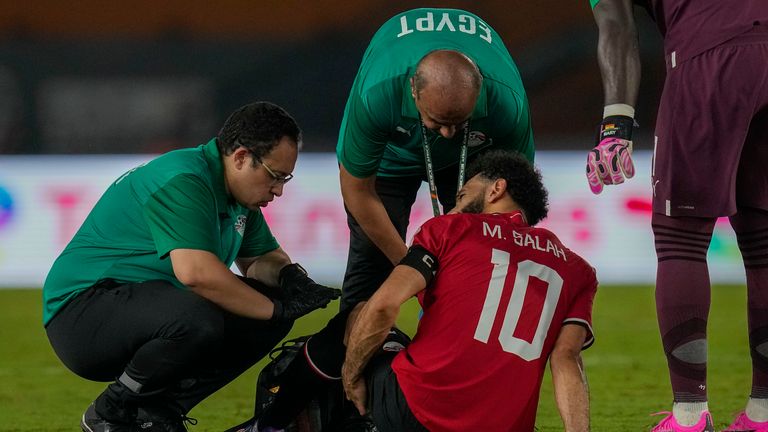 Egypt's Mohamed Salah receives medical treatment during the African Cup of Nations Group B soccer match between Egypt and Ghana in Abidjan, Ivory Coast, Thursday, Jan.18, 2024. (AP Photo/Themba Hadebe)