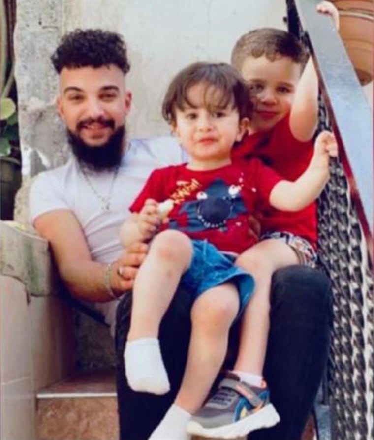 Abdel Rahman Al Bahsh sitting with family members. Bahsh died in an Israeli prison on New Year's Day.