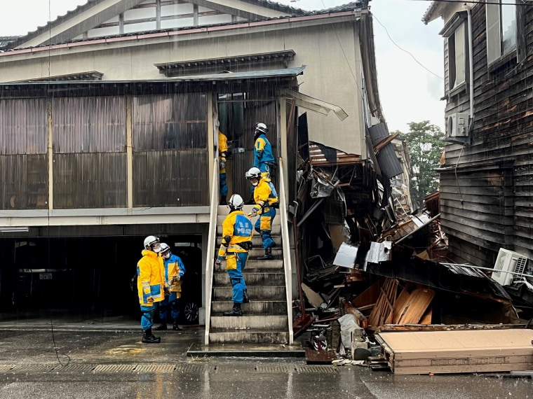 In Wajima, search and rescue crews went door to door to check damaged houses for survivors or bodies.