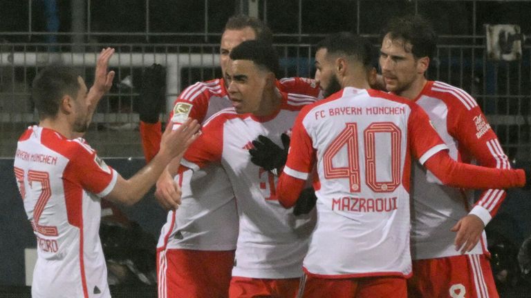 Jamal Musiala is congratulated by his team-mates after opening the scoring for Bayern Munich at Bochum