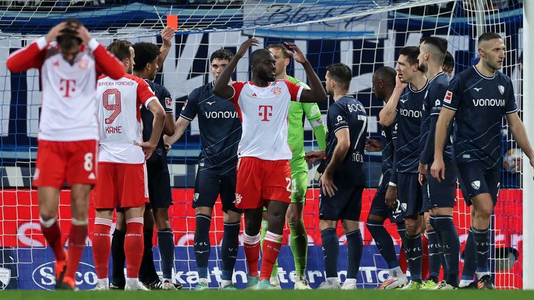 Referee Daniel Schlager shows a red card to Dayot Upamecano