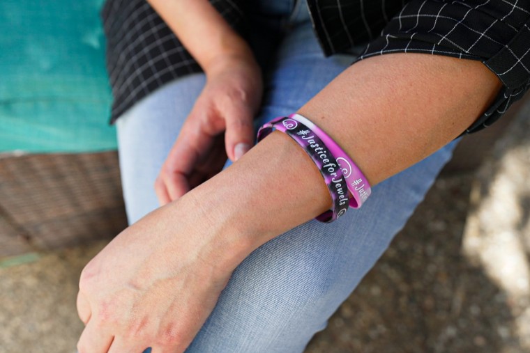 A woman wears bracelets.