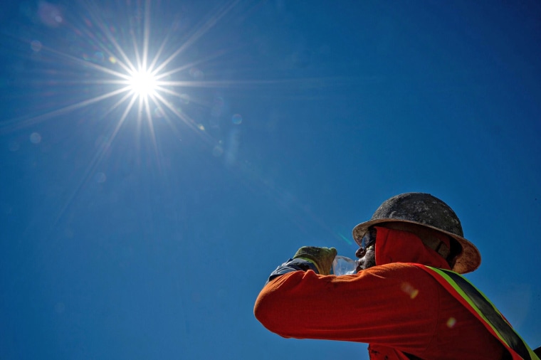 Aconstruction worker drinks water