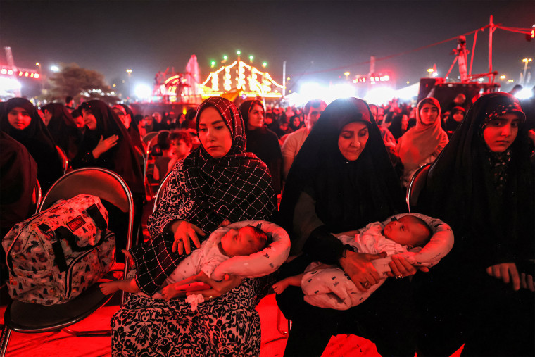 Families attend the "Moharram Shahr" exhibition at Azadi Square in Tehran on August 13, 2024. 