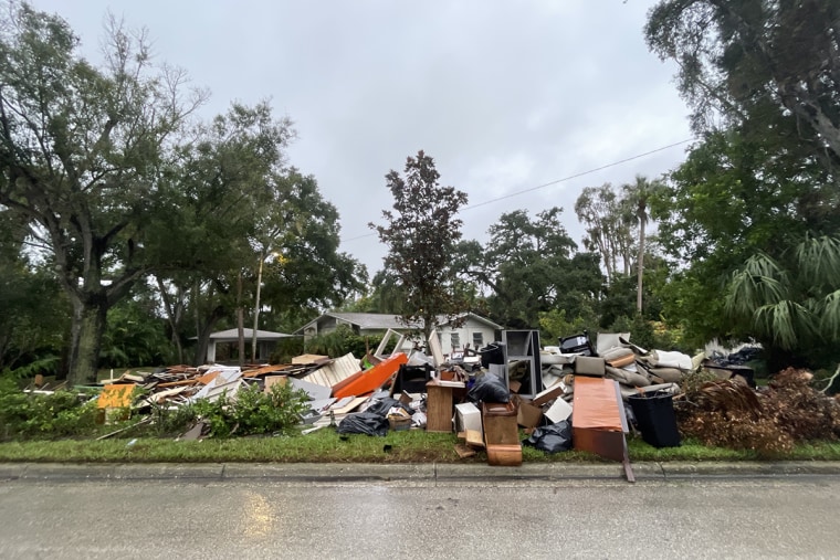 Contents of homes damaged by flooding from Hurricane Helene are piled on the side of the road in Tampa, Fla., ahead of Hurricane Milton.