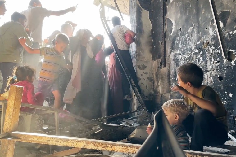 In stampeding hungry crowd, children wait in vain for bread