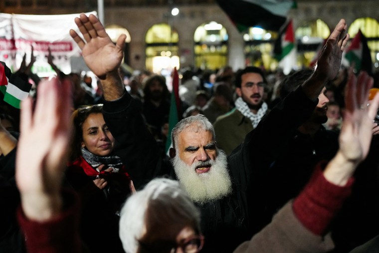 Protestors hold their hands in the air 