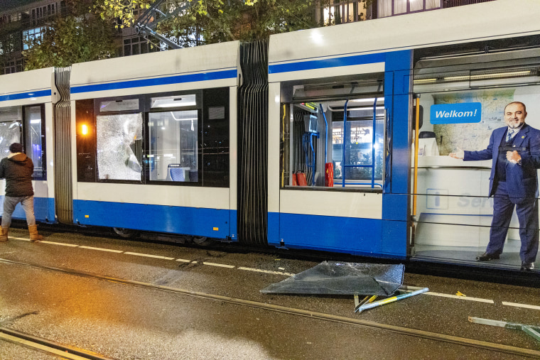 The windows of a tram are seen shattered after riots in Amsterdam