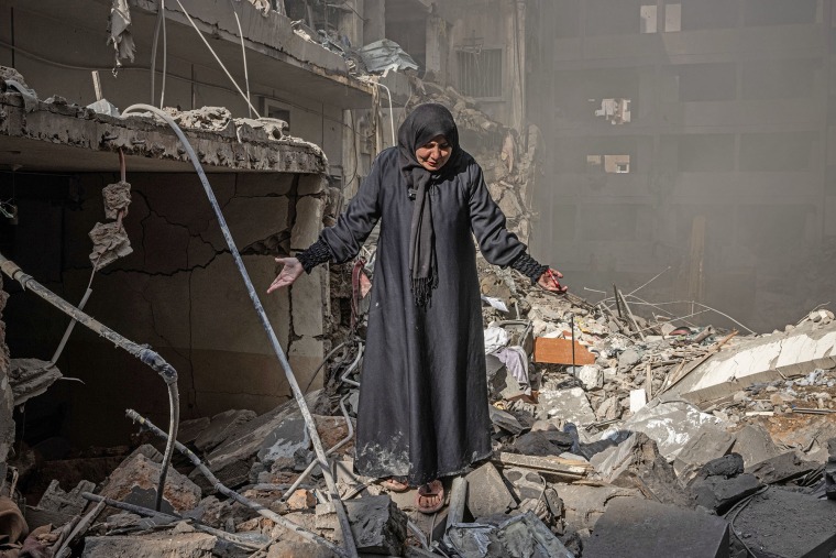 Miriam al-Shami, whose husband and mother-in-law were killed, cries where her destroyed home once stood at the site of an Israeli airstrike in Beirut's Basta district on Nov. 23 2024.