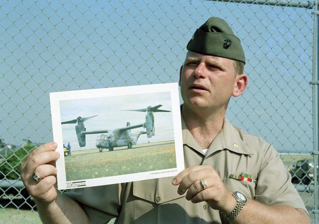  Maj. Barry Moore shows a photo of a V-22 Osprey aircraft at a news conference